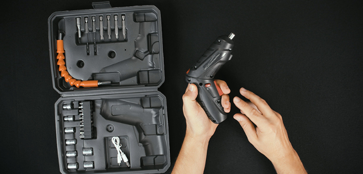 A man showing a case with accessories of Apex Drill